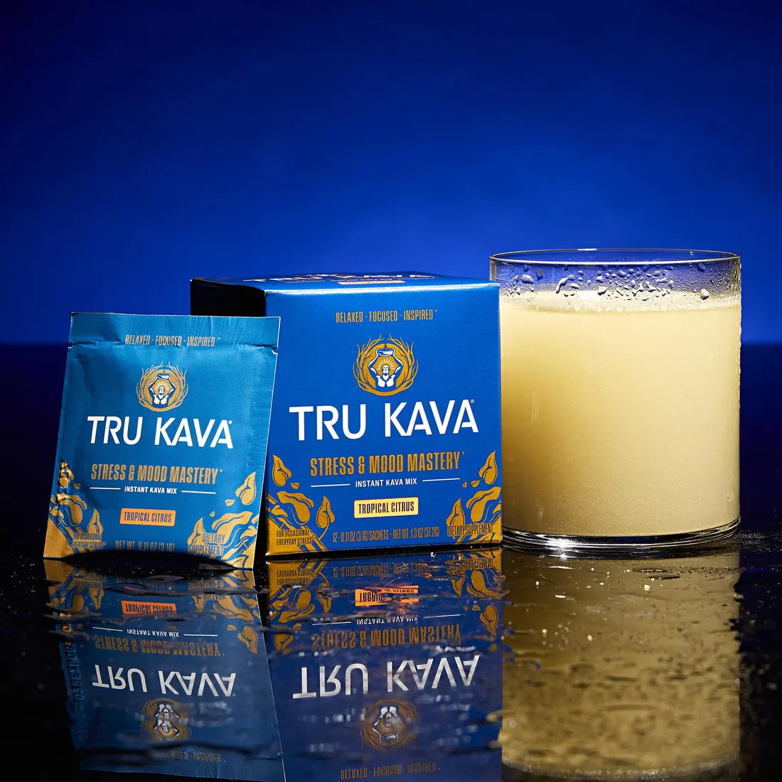 TRU KAVA Tropical Citrus box and sachet beside a prepared glass on a blue background