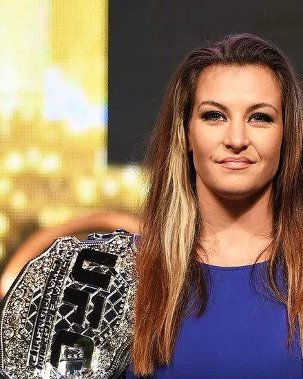 Miesha Tate holding a UFC championship belt