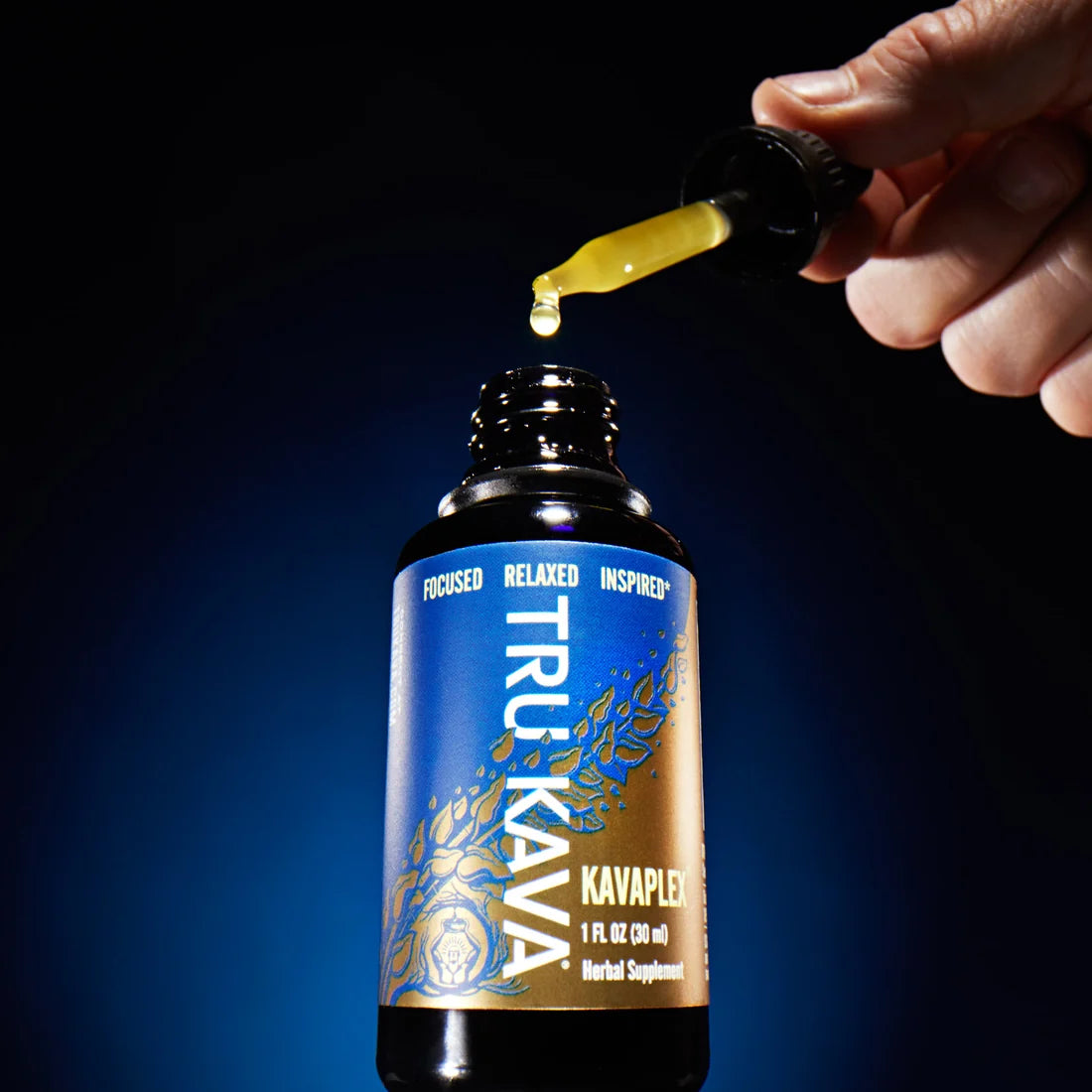 The KAVAPLEX dropper held above the bottle as a drop of golden whole-root kava oil falls