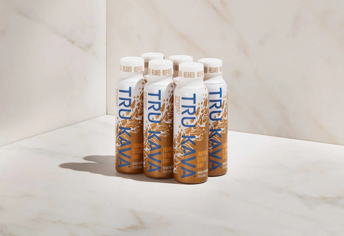 TRU KAVA Tropical Citrus Kava Shots six-pack on a light marble studio surface