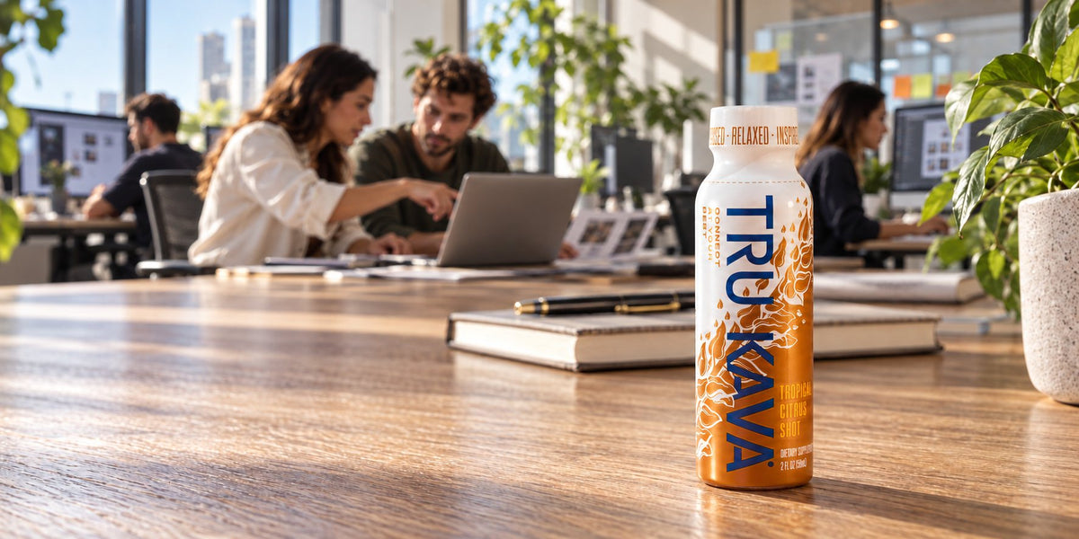A TRU KAVA Tropical Citrus Shot on a desk in a bright modern office