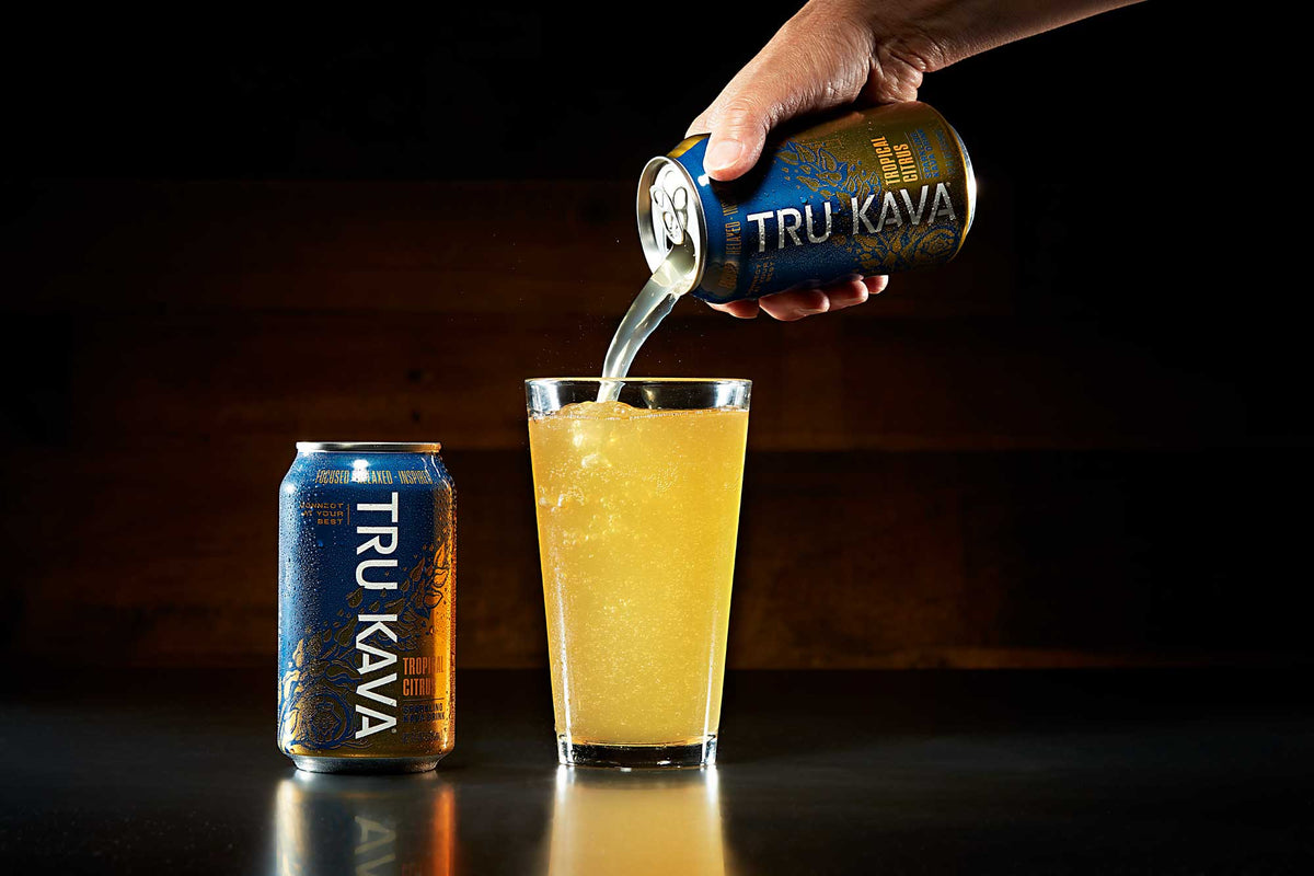 TRU KAVA Tropical Citrus sparkling kava being poured into a glass